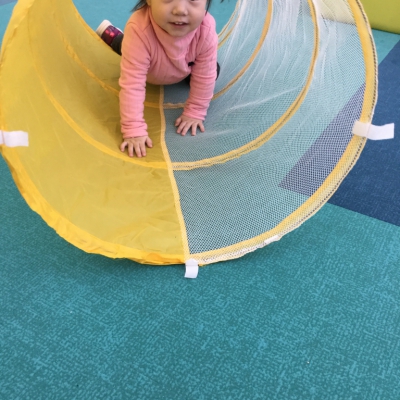 Little girl in tunnel, smiling