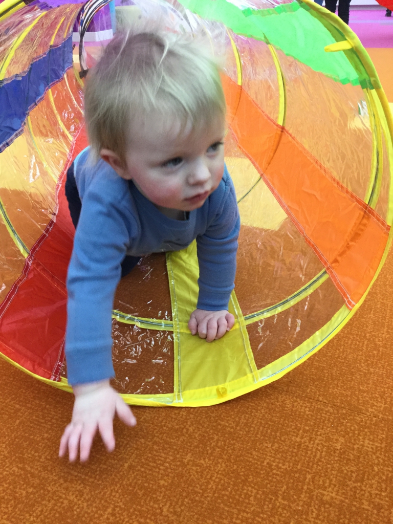 Tunnel Time Toddler climbing out of tunnel