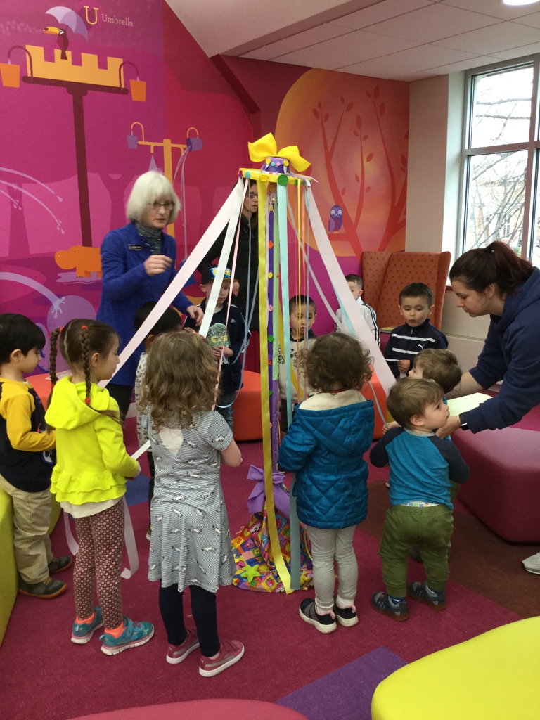 Maypole Storytime Children around maypole in Children's Room