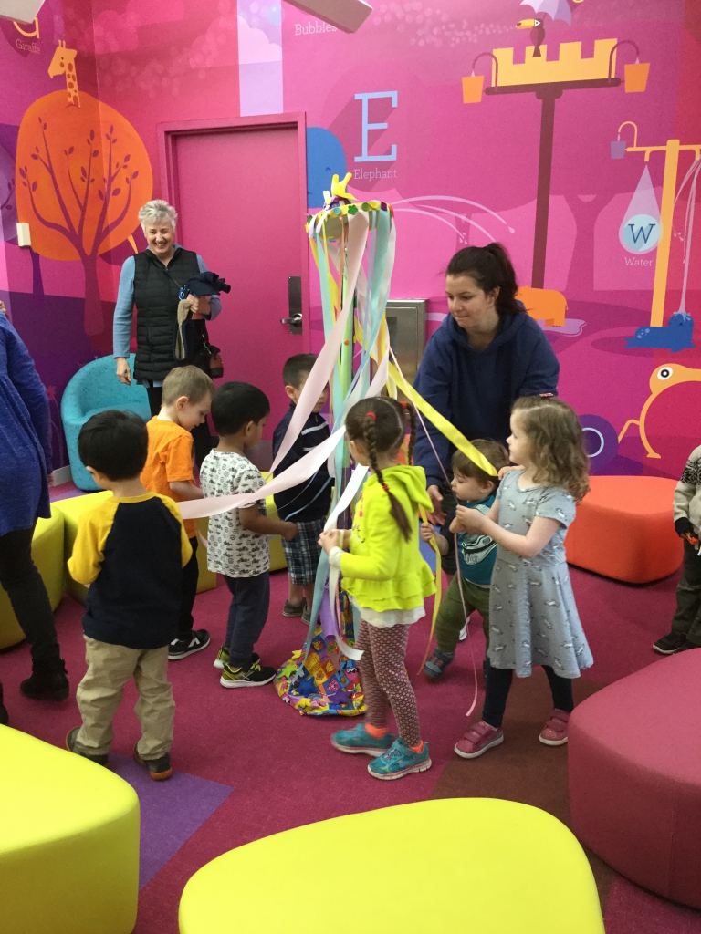 Maypole Storytime Children around maypole in Children's Room
