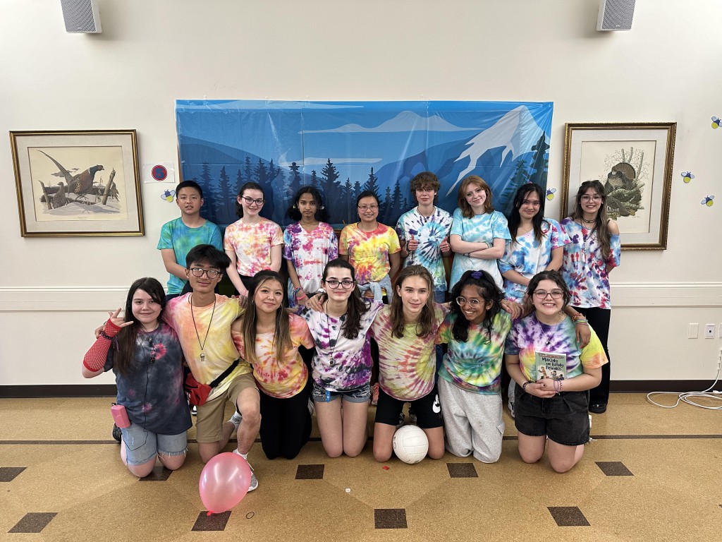 Group photo of teen volunteers Group photo of young teens wearing tie-dyed shirts