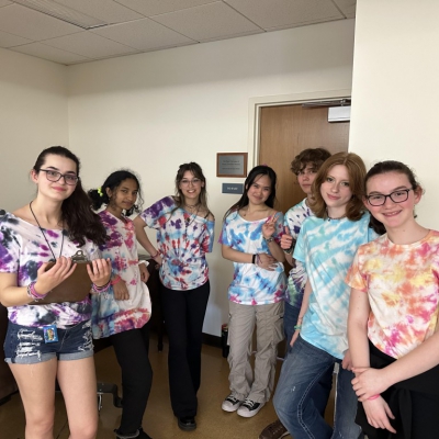 Group photo of young teens wearing tie-dyed shirts