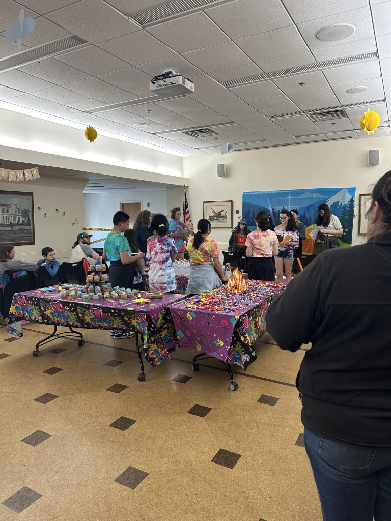 Did everyone lose their appetite for refreshments? Tables covered with cupcakes and people gathered around not looking at refreshments